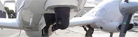 Airborne / UAV GimbalThe M1-D thermal pan tilt zoom system is mounted on a twin prop aircraft for flight testing. Many companies are selecting the M1-D as the future of low cost thermal aerial payloads.
