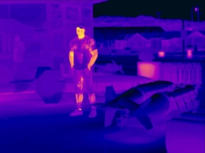 thermal image of a man near bombs