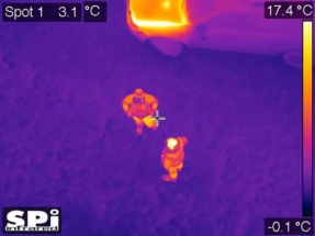 aerial thermal image of 2 men standing by a car with a hot engine bay