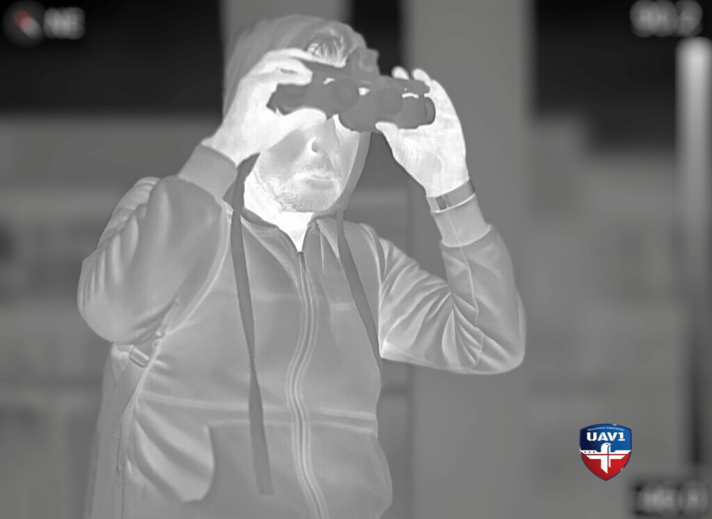 man using thermal imaging binoculars
